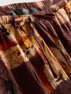 Pantalones anchos de satén arrugado florales