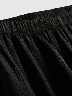 Pantalones cortos deportivos de satén holgados