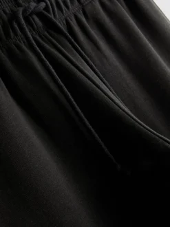 Pantalones de chándal anchos con aplicación