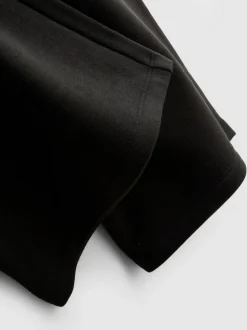 Pantalones de chándal anchos con aplicación
