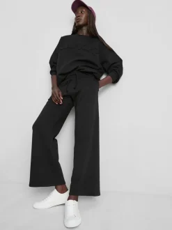 Pantalones de chándal anchos con aplicación