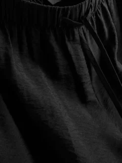 Pantalones fruncidos de pernera ancha