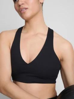 Top corto deportivo con cuello de pico y sujeción suave