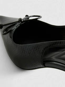 Zapatos destalonados con tira posterior y lazo